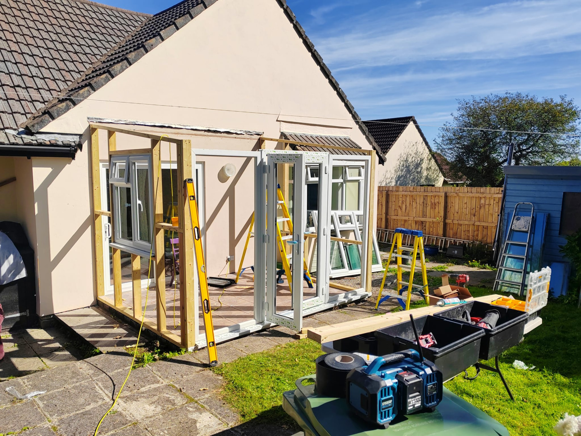 Sunroom project during works: timber frame and new UPVC windows and French doors being installed