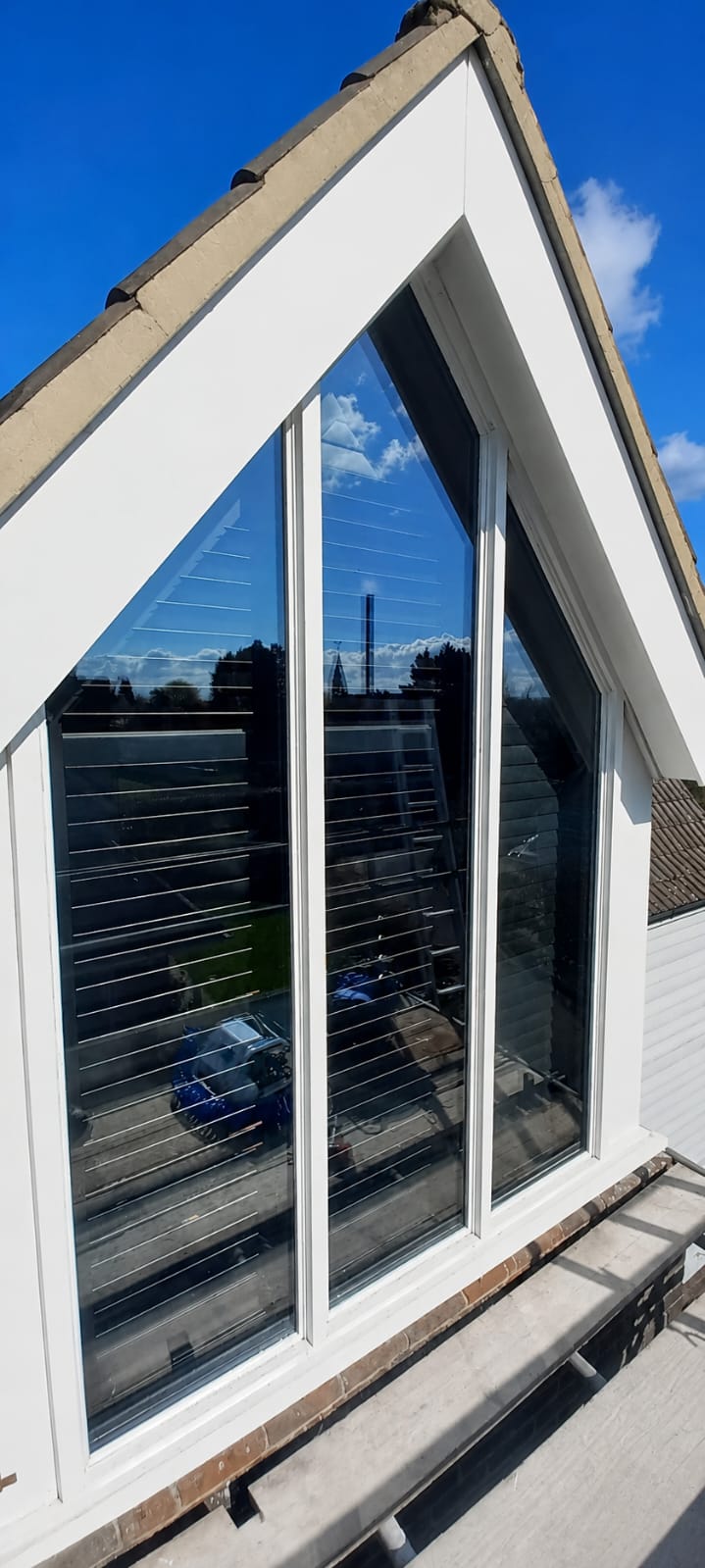 Bespoke white apex gable window with slim glazing bars in a pitched roof